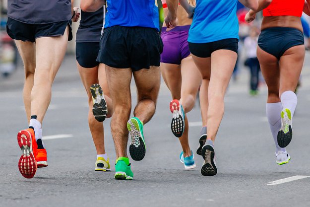 legs mixed group runners athletes running marathon in road, male and female joggers summer sports race